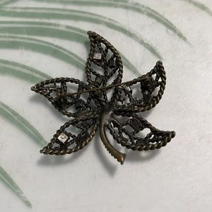 Rhinestone accent leaf pin.